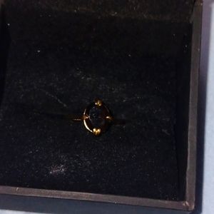 Stamped gold ring with dark blue ruby